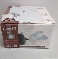 Box of pet water fountain with product image, model YS-03, and description of multi-stage purification features.