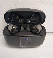 Open charging case with black wireless earphones inside, showing the earbuds and LED battery indicator 8 on the front of the case.