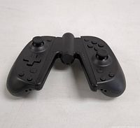 Front view of Nintendo Switch Joy-Con controllers attached to the black Joy-Con grip showing analog sticks, buttons, and overall assembly.