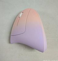 Top view of pink ergonomic vertical mouse showing smooth matte finish and white scroll wheel
