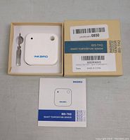 Inkbird IBS-TH2 smart temperature sensor in box with white device and included manual, original packaging showing product model and manufacturing details