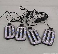 Four rectangular LED light panels with white, red, and blue LEDs and wired connections.