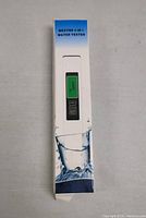 Front view of boxed MEXYBE 4-in-1 Water Tester showing device image with digital screen and button layout.
