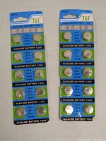 Front view of two blister packs, each containing 10 T&E alkaline button cell batteries of various sizes.