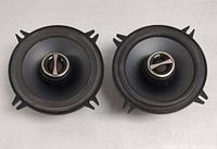 Top view of two car subwoofer speakers with black cones and central tweeter.