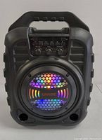 Front view of Carise Bluetooth portable speaker with LED lights active showing colorful illumination on speaker grille.