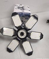 Top view of the six LED panels arranged around the central base showing numerous small LED bulbs.