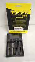 LiitoKala Lii-M4S charger with 4 battery slots and LCD display, shown out of package.