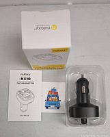 Photo showing the wireless FM transmitter inside clear plastic mold with user manual and original box.