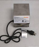 Rotisserie Drive Motor front view showing stainless steel housing, power cord and plug, with visible product label and brand 'onlyfire'.