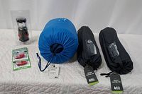 All items displayed together on white quilted surface