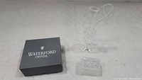 Waterford Crystal harp figurine and original box with Hermanglas handled pitcher or vase and Chung Chung trinket dish on white surface.