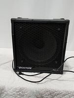 Front view showing speaker, grille and branding