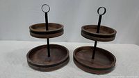 Two Mikasa 2-tier lazy susans made of mango wood and metal, both positioned side by side.