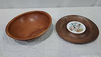 Two wood items: cherry wood bowl on left, Woodbury Woodware serving tray on right with bird motif