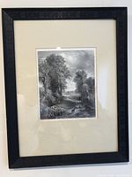 Framed black and white steel-engraved print depicting a rural landscape with sheep, trees, and a path, under glass in a black frame with detailed border.