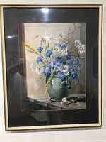 Full view of the framed pastel painting showing the floral bouquet in a green vase, black matte border, and light wood frame.