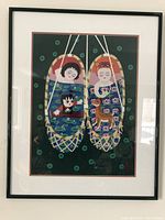 Framed painting showing colorful depiction of figures in woven baskets with water lilies and animals, set on dark green background.