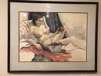 Full view of the framed watercolor painting showing a nude woman reclining and holding an apple with a bowl of apples nearby.
