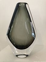 Full view of the teardrop-shaped vase showing clear exterior and smoky gray interior