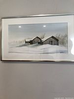 Full view of the framed watercolor painting showing three rustic barns in a snowy winter landscape.
