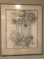 First framed watercolor painting showing forest scene with trees and bushes