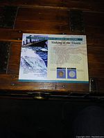 Front side of the Titanic information card with images of the two coins and historical text.