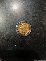 Obverse side showing George Washington profile, 2009 D mint mark, gold plated coin in protective case.