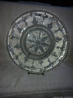 Top view of one vintage Federal Heritage glass plate 11.5 inches in diameter showing embossed floral and textured dot pattern.