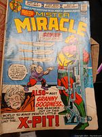 Close up of vintage Mister Miracle comic book cover showing worn edges and colorful artwork