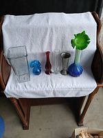 Group photo of six vintage vases on white cloth showing full lot.