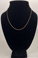 18" 14K yellow gold rope chain necklace displayed on black velvet bust showing overall length and design