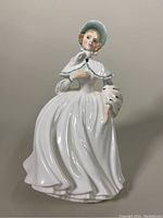 Front view of the 7.75 inch Royal Doulton porcelain figurine Jessica showing detailed face, bonnet, and flowing dress.