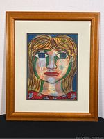 Full view of the framed mixed media portrait painting showing the frame and matting.