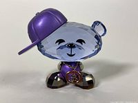 Front view of Swarovski Hip-Hop Bear Crystal Figurine showing detailed face, hat, and medallion