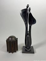 Front view of both metal sculpture and starburst canister