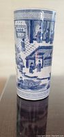 Blue and white porcelain vase with detailed scenes of daily life painted around the vase. Shows figures, buildings, and decorative border patterns.