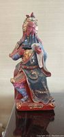 Front view of the porcelain Chinese God of War statue, showing detailed features and colorful attire.