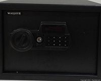 Black WASJOYE digital safe showing keypad, circular handle, and keyhole on front.