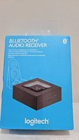 Front view of the Logitech Bluetooth Audio Receiver box showing product image and branding.