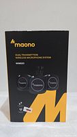 Front of product box showing Maono branding and model WM820 with illustration of the dual transmitters and receiver.