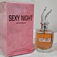Photo showing Sexy Night perfume bottle with silver legs cap and pink box with product name and details.