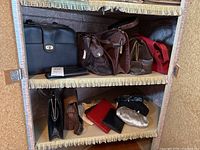 Wide view showing multiple vintage faux leather purses and wallets on shelves, including black, brown, red, and metallic items