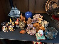 Top view showing entire assortment including brass owl, amethyst clusters, ceramic dogs, gnome figurines and more.