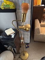 Full view of the dual shade floor lamp with both metal and frosted glass shades visible, wood and metal components visible