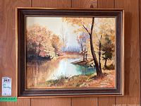 Full view of the framed oil painting showing autumn landscape and signature.