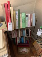 Photo showing multiple boxed card sets including 51 Christmas Assortment and other stationery boxes arranged on a metal rack.