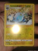 Close-up of the Arctozolt reverse holo Pokemon card showing the holographic electric type background and card details.