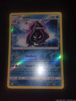 Photo of the Cloyster reverse holo Pokemon card showing the holographic effect and card details