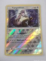 Close-up image of a Kangaskhan reverse holo Pokemon card showing holographic shine and card details.